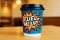 Pop art coffee cup with FUEL ME UP text on blue background with stars and comic elements. Royalty Free Stock Photo