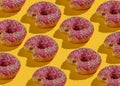 Pop art collage of bitten glazed donuts on a yellow background. Food background