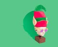 Pop art minimal concept. Christmas and New Year party. Statue head with Elfs hat and party sunglasses.. Green background, copy