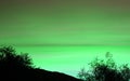 Pop Art Surreal Style Gradient Green Sky over the Silhouette of Foliage and Hill Royalty Free Stock Photo