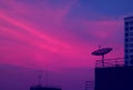 Vibrant Blue and Purple Tone Satellite Dish on the High Building Against Evening Sky Royalty Free Stock Photo