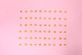 Pop corn seeds symmetric on pink paper