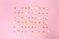 Pop corn seeds symmetric on pink paper