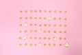 Pop corn seeds symmetric on pink paper