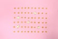 Pop corn seeds symmetric on pink paper