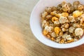 Pop corn on white bowl on wood background