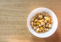 Pop corn on white bowl on wood background