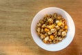 Pop corn on white bowl on wood background