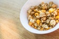 Pop corn on white bowl on wood background