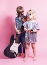 Pop Culture: Children a boy with a guitar and a girl with a microphone pretend to be popular musicians and perform a