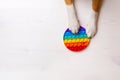 Pop it. Dog playing with trendy popular rainbow colorful anti stress toy.