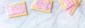 Pop tart, or toaster pastry panorama, top shot on a marble background Royalty Free Stock Photo