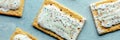 Pop tarts panorama. Poptart toaster pastry with icing on blue Royalty Free Stock Photo