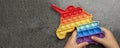 Pop it toy, rainbow colors, in the form of a unicorn. Colorful, multi-colored, sensory anti-stress toy fidget pop it in
