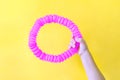 Pop tube. anti stress sensory plastic toy from a pop tube in the hands of a child trend of 2021
