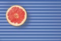 Popart style red grapefruit on a striped background top view