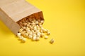 Popcorm paper bag on a yellow background Royalty Free Stock Photo