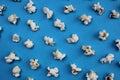 Texture salty crunchy freshly cooked popcorn on a blue background Royalty Free Stock Photo