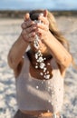 Popcorn beach. Defocused blonde woman throwing pebbles on the beach. Fuerteventu