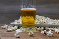 Popcorn and beer on wooden table Royalty Free Stock Photo