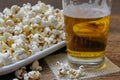 Popcorn and beer on wooden table Royalty Free Stock Photo