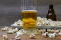 Popcorn and beer on wooden table Royalty Free Stock Photo