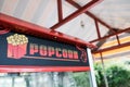 Popcorn booth signboard. Buying popped corn for a romantic evening date in movie theater. Unhealthy snacks sign in cinema to snack