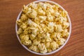 Popcorn in bowl. Brown background