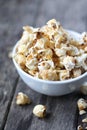Popcorn in bowl with wooden background Royalty Free Stock Photo