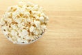 Popcorn bowl on wooden table Royalty Free Stock Photo