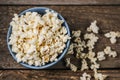 Popcorn in a bowl on wooden table Royalty Free Stock Photo
