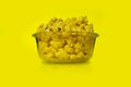 Popcorn in a bowl with yellow background - Front view Royalty Free Stock Photo