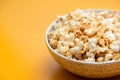 Popcorn in bowl on yellow background Royalty Free Stock Photo