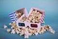 Popcorn bucket against a blue background Vintage Retro Filter. Royalty Free Stock Photo