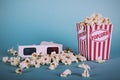 Popcorn bucket against a blue background Vintage Retro Filter. Royalty Free Stock Photo