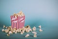 Popcorn bucket against a blue background Vintage Retro Filter. Royalty Free Stock Photo