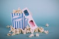 Popcorn bucket against a blue background Vintage Retro Filter. Royalty Free Stock Photo