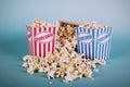 Popcorn bucket against a blue background Vintage Retro Filter. Royalty Free Stock Photo