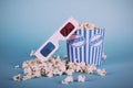 Popcorn bucket against a blue background Vintage Retro Filter. Royalty Free Stock Photo