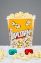 Popcorn bucket overflowing and 3d glasses Royalty Free Stock Photo
