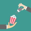 Popcorn. Businessman hand. Salt shacker with hearts. Cinema icon in flat design style.