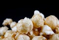 Popcorn in caramel, macrophoto on a black background