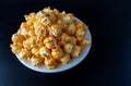Popcorn with cheddar cheese flavor on a plate Royalty Free Stock Photo