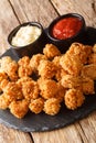 Popcorn chicken is a dish consisting of small bite sized pieces of chicken that have been breaded and fried closeup in the slate