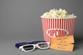 Popcorn, cinema tickets and 3d glasses on background. Space for text Royalty Free Stock Photo
