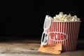 Popcorn, cinema tickets and 3d glasses on table against black background. Space for text Royalty Free Stock Photo