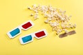 Popcorn, cinema tickets and 3D glasses on yellow, Movie time concept Royalty Free Stock Photo