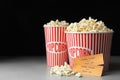 Popcorn and cinema tickets on table