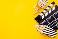 Popcorn with clapperboard and movie film reel. Cinema background Royalty Free Stock Photo