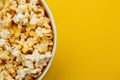 Popcorn closeup viewed from above on yellow background. Flat lay of pop corn bowl. Top view Royalty Free Stock Photo